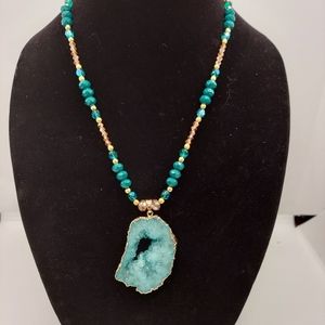 Glass and metal beads with geode pendant